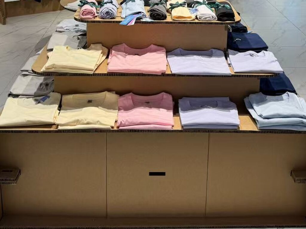 Garments on a cardboard display table in store